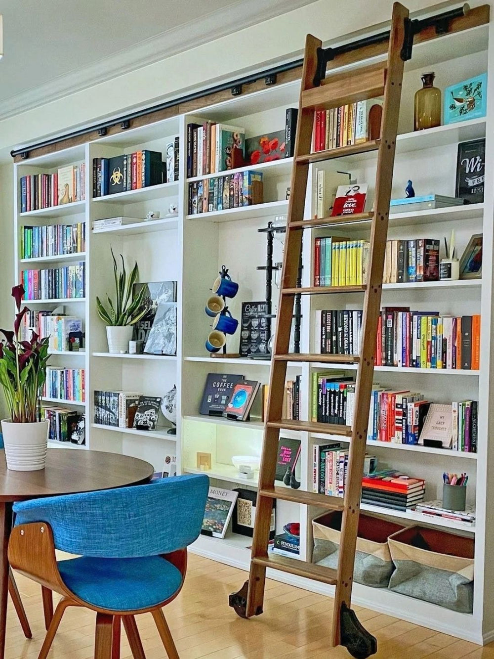 Classic rolling library ladder on white bookshelves.