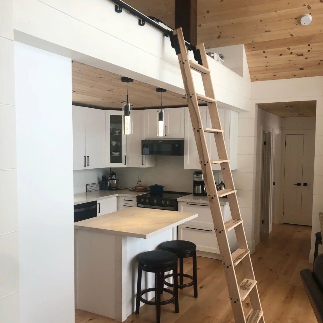 Custom loft ladder beside a kitchen.