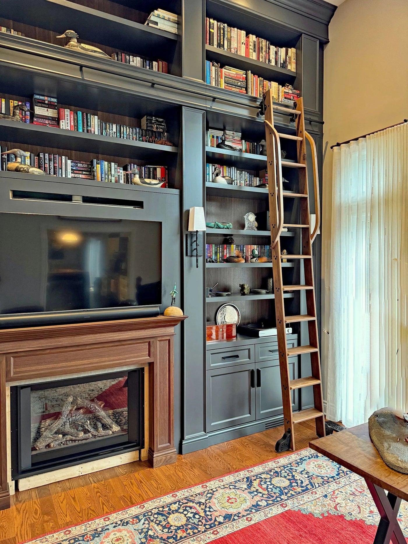 Handcrafted rolling ladder by Custom Ladder Company.