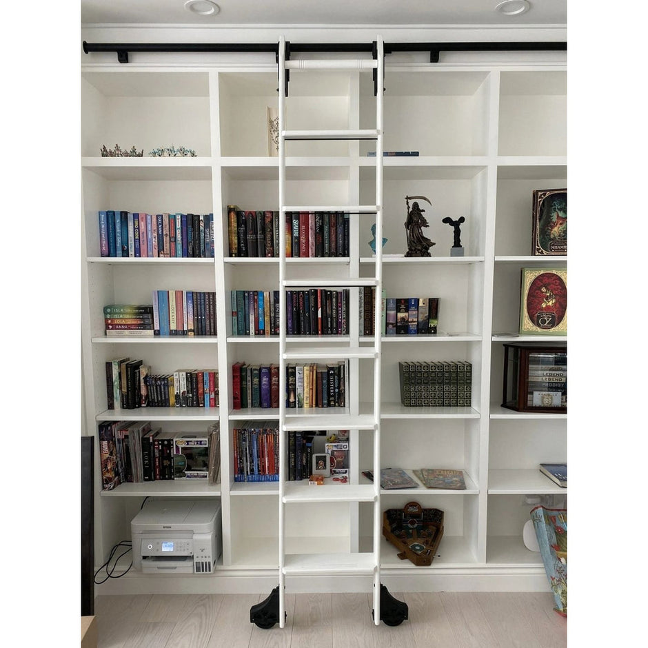 White library ladder kit on white bookshelves.
