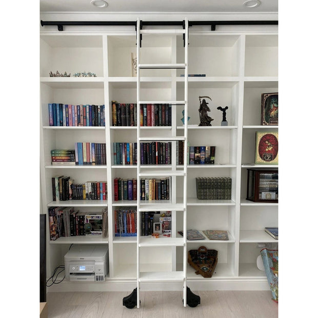 White library ladder kit on white bookshelves.